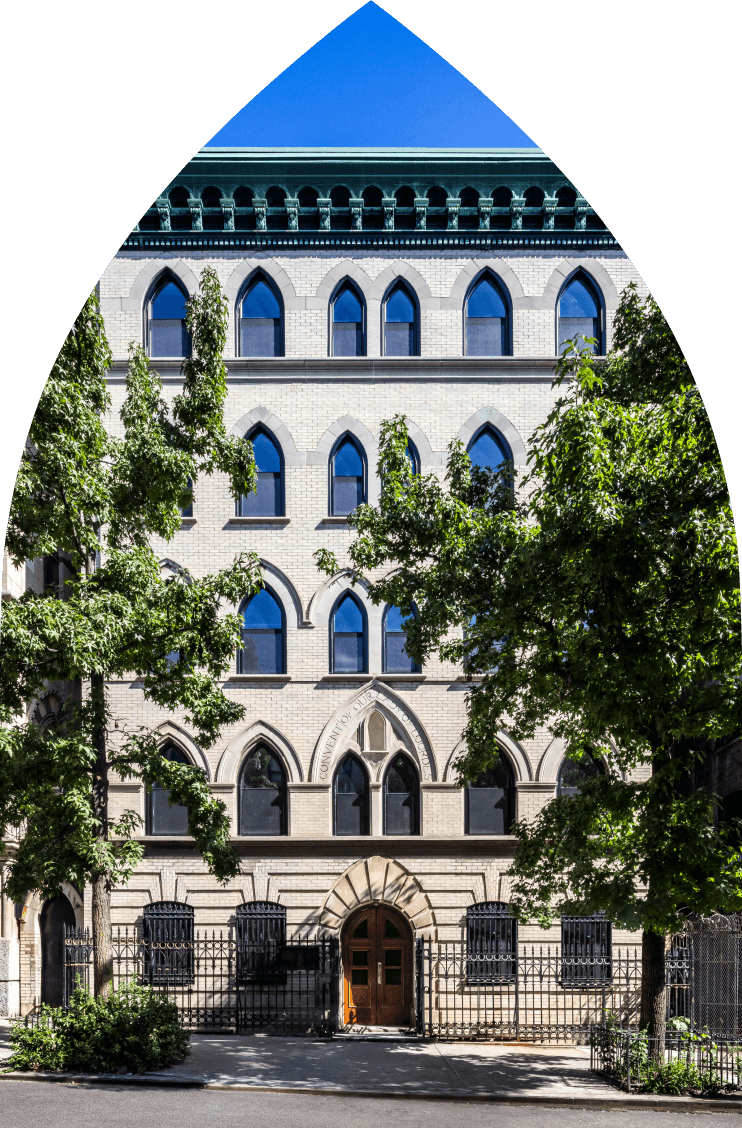 463 W 142 Harlem condominium building facade with neo-Gothic arched windows on tree-lines street in Hamilton Heights.