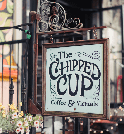 Coffee shop with sign that says The Chipped Cup Coffee and Victuals in Hamilton Heights NYC near 463 West 142 condominium.